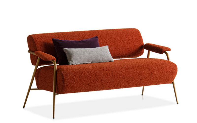 Orange textured loveseat sofa with purple and grey cushions.