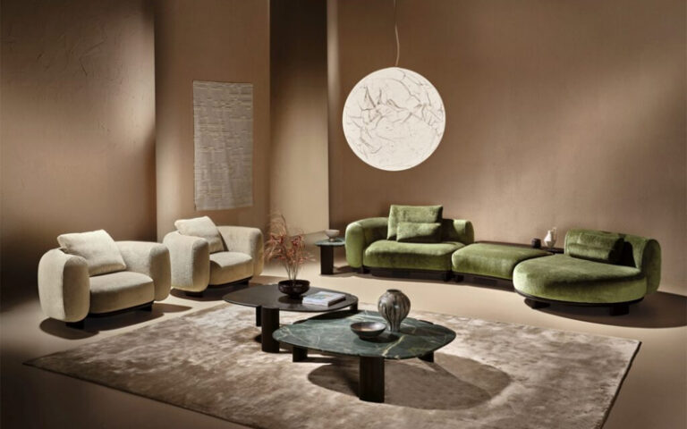 Elegant interior featuring rounded cream and tan boucle sofas and a marble coffee table.