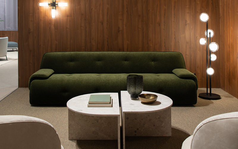A sophisticated olive green velvet sofa with deep button tufting