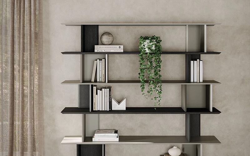 A stylish, floor-to-ceiling modern bookshelf in a minimalist home